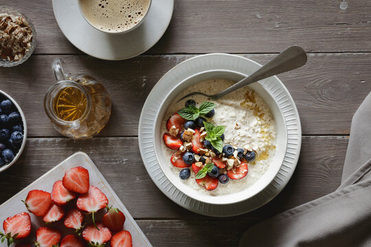 Studio shot of bowl of porridge with blueberries and strawberries