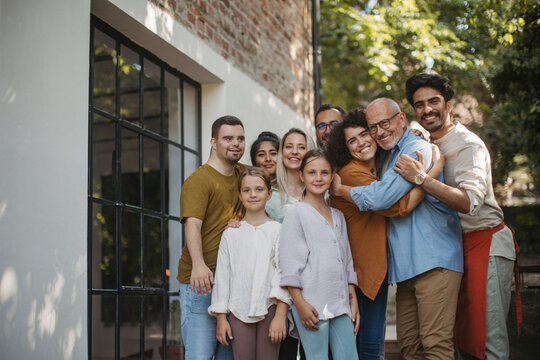 Diverse group of community members embracing successful community project