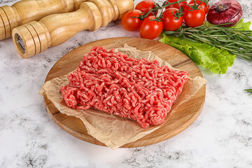 Raw minced beef meat on cutting board