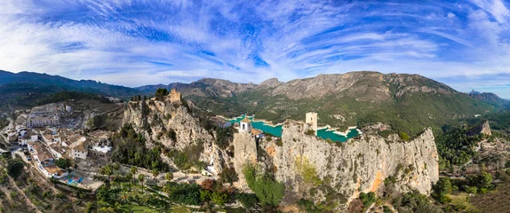 Poster Landmarks of Spain. medieval village Guadalest, aerial drone view scenery with castle on the rocks and turquoise lake. Alicante province © Freesurf