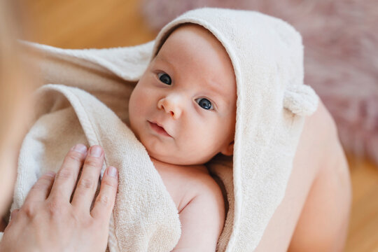 Mother with cute son wrapped in towel