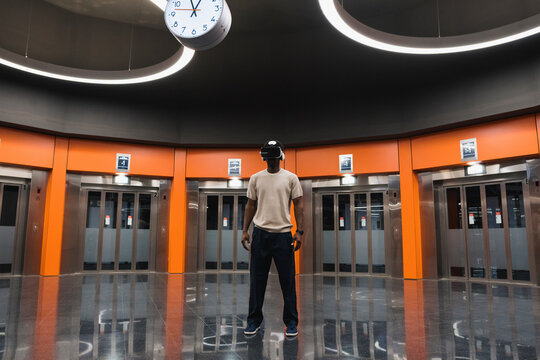 Young man using Virtual Reality Simulator at Metro Station