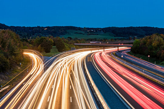 Germany, Baden-Wurttemberg, Leonberg, Vehicle light trails stretching alongBundesautobahn8 at dusk