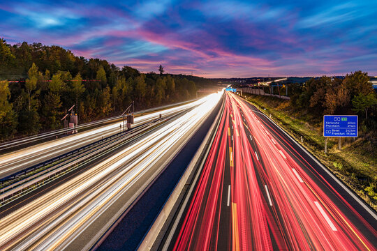 Germany, Baden-Wurttemberg, Leonberg, Vehicle light trails stretching along Bundesautobahn 8 at dusk