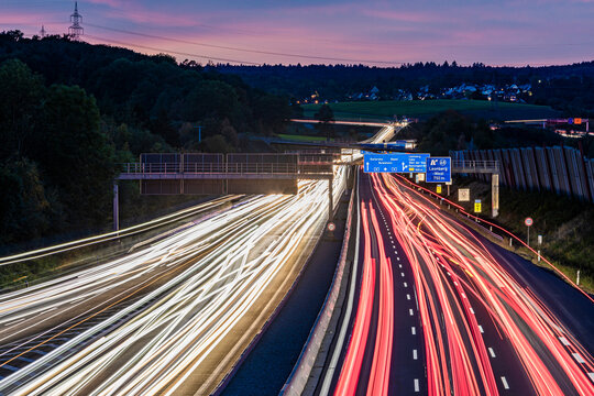 Germany, Baden-Wurttemberg, Leonberg, Vehicle light trails stretching alongBundesautobahn8 at dusk