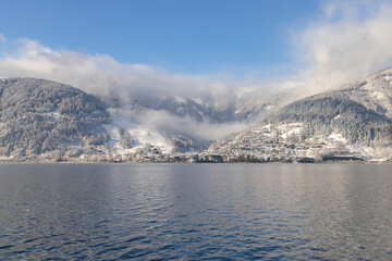 Winterlandschaft mit Stadt und See.