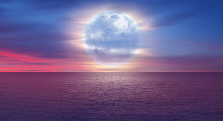 Full moon over the sea at sunset "Elements of this image furnished by NASA"
