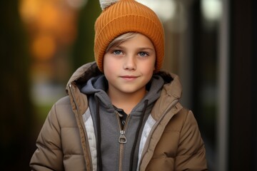 Outdoor portrait of cute little boy wearing warm hat and coat.