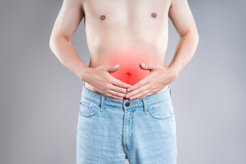Stomach ulcer, man with abdominal pain on a gray background, symptoms of gastritis, diseases of the...