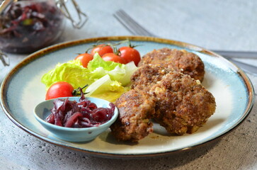 Fried meatballs with vegetables on the table. Selective focus.