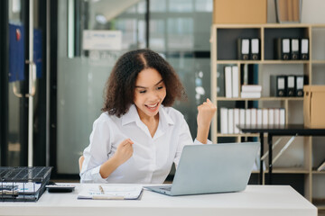 Fototapeta premium Confident business expert attractive smiling young woman typing laptop and holding digital tablet