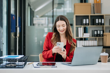 Confident business expert attractive smiling young woman typing laptop and holding digital tablet