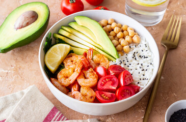 Bowl with rice, shrimp, avocado, tomato, chickpeas and lime. Healthy eating. Diet.