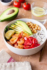 Bowl with rice, shrimp, avocado, tomato, chickpeas and lime. Healthy eating. Diet.