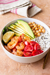Bowl with rice, shrimp, avocado, tomato, chickpeas and lime. Healthy eating. Diet.