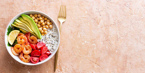Bowl with rice, shrimp, avocado, tomato, chickpeas and lime. Healthy eating. Diet.