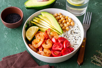 Bowl with rice, shrimp, avocado, tomato, chickpeas and lime. Healthy eating. Diet.