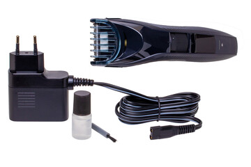 Closeup of a new black and silver rechargeable beard and hair clipper with power supply, brush and...