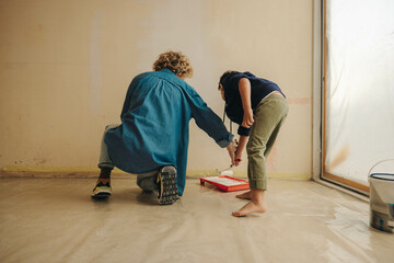 Mom and son bonding in creative home renovation project