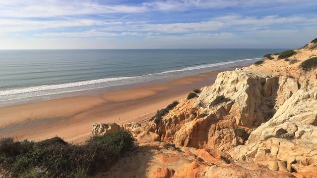 Arenosillo beach, located in Huelva, Spain. Explore the serene beauty of this coastal paradise with its sunlit sandy shores and the rhythmic ebb and flow of the Atlantic Ocean.