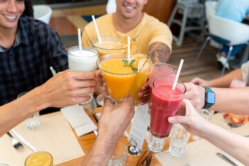 Group of Friends Celebrating with Juices at Breakfast Restaurant
