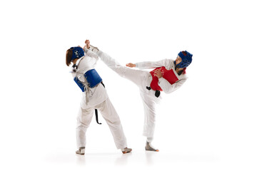 Kick and protection stunts. Young girls, taekwondo athletes in motion, practicing isolated over...