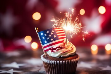 burning sparkler on cupcake against defocused usa flag background