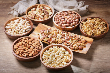 bowls of mixed nuts on wooden background