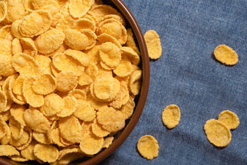 Dry corn flakes in a bowl, close-up. Top view