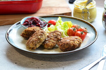 Meatballs with salad and cherry tomatoes on a plate. Selective focus.