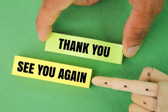 finger holding colored paper with the words thank you and see you again. the concept of gratitude