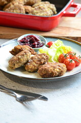Meatballs with salad and cherry tomatoes on a plate. Selective focus.