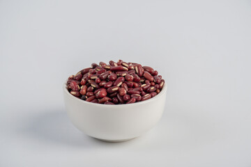 Red kidney beans in white cup on white background