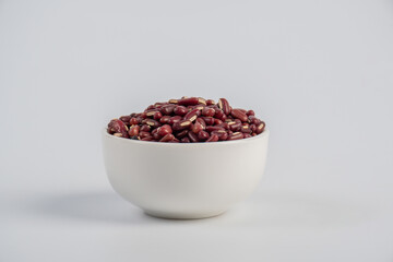 Red kidney beans in white cup on white background