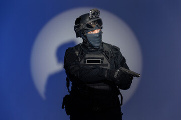 Portrait soldier in black uniforms with gun in studio. Concept Military warrior army tactical force to fight crime in city