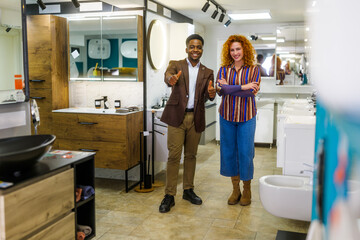 Portrait of young couple who owns small business bath store. Man and woman work in partnership.