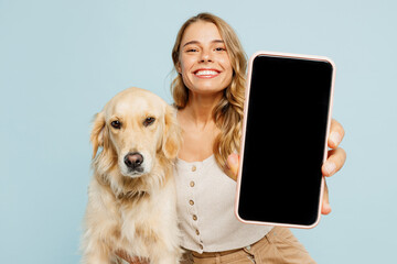 Young owner woman with her best friend retriever wear casual clothes use blank screen area mobile...