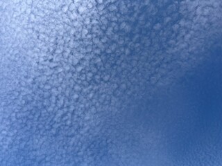 Experience the Calmness of a Clear Day as White Clouds Waltz Across the Deep Blue Sky