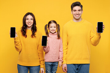 Young happy fun parents mom dad with child kid girl 7-8 years old wear pink sweater casual clothes...