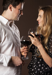 Young happy couple enjoying a glasses of wine