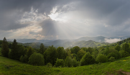 Mountain ridges in spring sunny evening after a rain, panorama