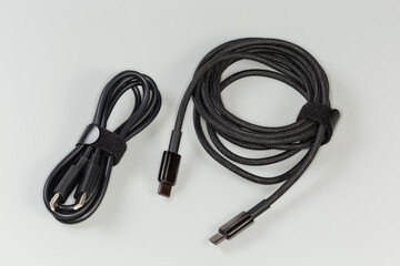 Two different black cable USB Type-C on gray background