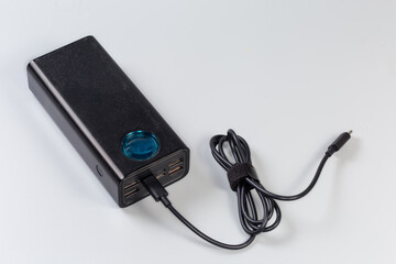 Power bank with several different ports and connected USB cable