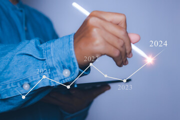Businessman pointing target in 2024. Progress business growing potential success