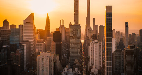 Scenic Aerial New York City Evening View of Lower Manhattan Architecture. Panoramic Downtown Photo from a Helicopter at Sunset. Cityscape with Modern Office Buildings and Historic Skyscrapers