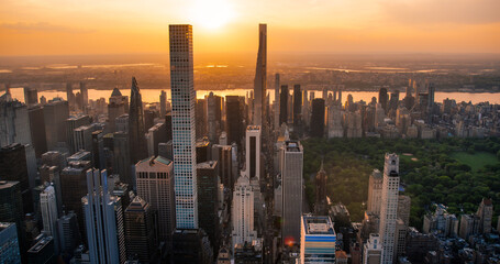 New York Cityscape at Sunset. Aerial Shot from a Helicopter. Modern Skyscraper Buildings with...