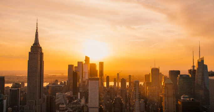 Scenic Aerial New York City Evening View of Lower Manhattan Architecture. Panoramic Downtown Photo from a Helicopter at Sunset. Cityscape with Modern Office Buildings and Historic Skyscrapers - Powered by Adobe
