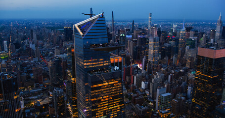 Evening Panorama Around 30 Hudson Yards Skyscraper in New York City, USA. Night Aerial Photo with a Modern Skyscraper with Crowded Observation Balcony. Travelers Looking on the Panorama - obrazy, fototapety, plakaty