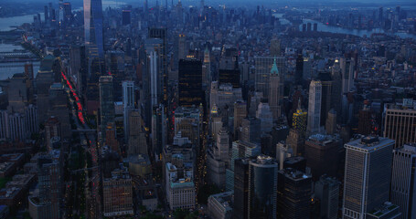 Wall Street Office Buildings at Night: Scenic Aerial New York City View of Lower Manhattan...