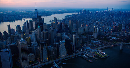 Obraz premium Cinematic Aerial Evening Shots Capturing New York City Skyscrapers. Panoramic Helicopter Fly-By Over the Roofs and Spires of Historic Urban Architecture in Wall Street Financial District